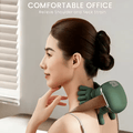 Woman using a green neck and shoulder kneading massager at her office desk